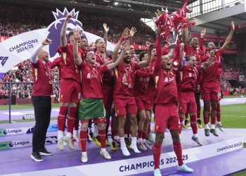 Liverpool players raise Premier League trophy in front of Klopp
