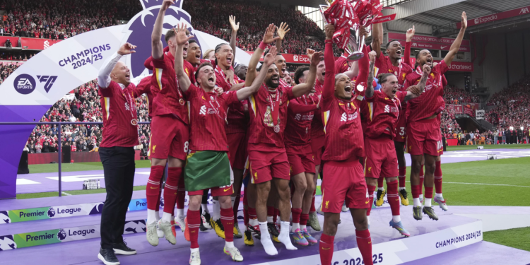 Liverpool players raise Premier League trophy in front of Klopp