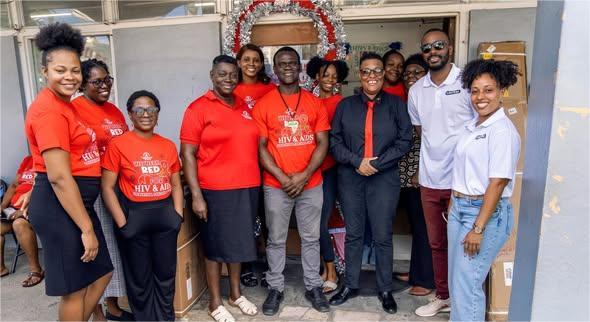 Caution J’ouvert makes timely donation to AIDS Secretariat